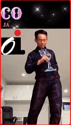 a man is holding a glass of wine in front of a sign that says co ja