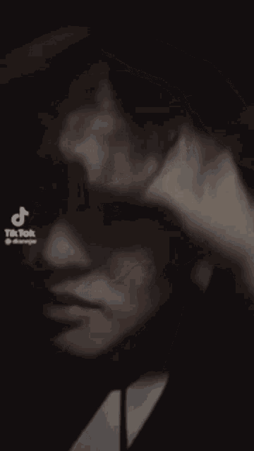 a close up of a man 's head with a tiktok watermark