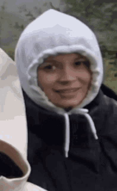 a close up of a person wearing a white hoodie .