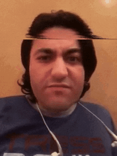 a man wearing headphones and a blue shirt that says ' texas ' on it