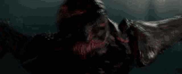 a close up of a monster with blood coming out of its mouth .