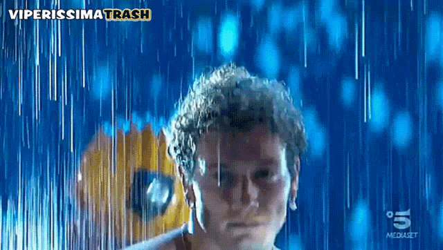 a man is standing in the rain with the number 5 on the bottom
