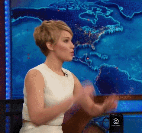 a woman in a white dress is talking in front of a map of the world