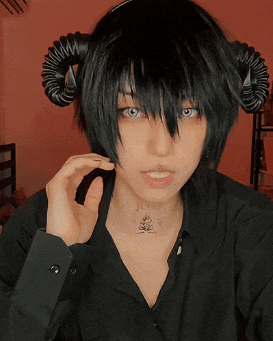 a girl with horns and a tattoo on her neck