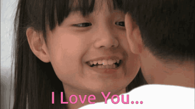 a little girl is being kissed by a boy and the words i love you are visible
