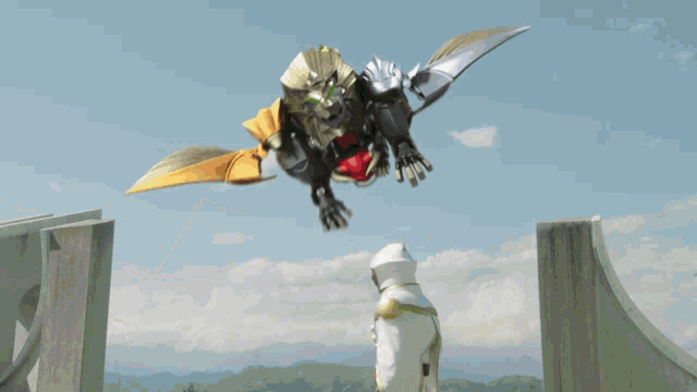 a statue of a lion with wings is flying in the sky