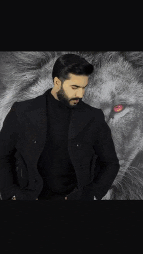 a man in a black suit is standing in front of a lion