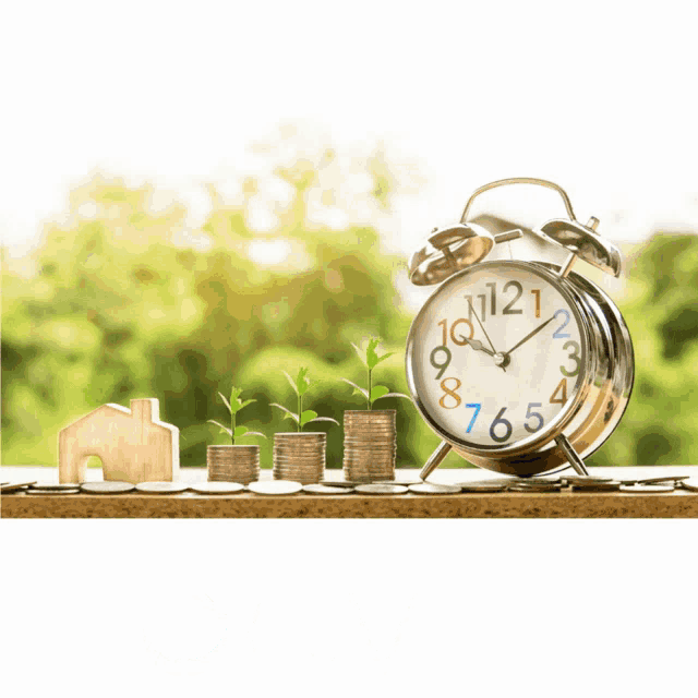 an alarm clock sits on a table with stacks of coins and a giv logo