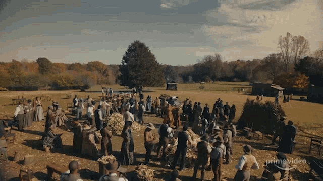 a large group of people are gathered in a field with a prime video logo in the corner
