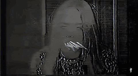 a close up of a woman 's face with a microphone on her head .