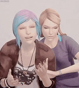a woman with blue hair is hugging another woman with blonde hair .