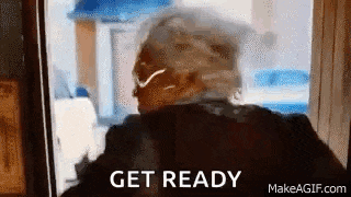 a woman is standing in front of a window with the words `` get ready '' written on the bottom .