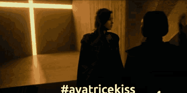 a woman stands in front of a cross with the hashtag #avatricekiss on the bottom