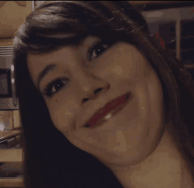 a close up of a woman 's face making a funny face