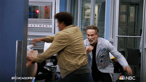 two men fighting in front of a sign that says " partment "