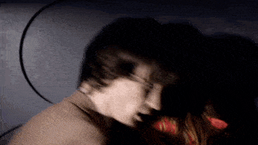 a blurry picture of a man and a woman 's faces