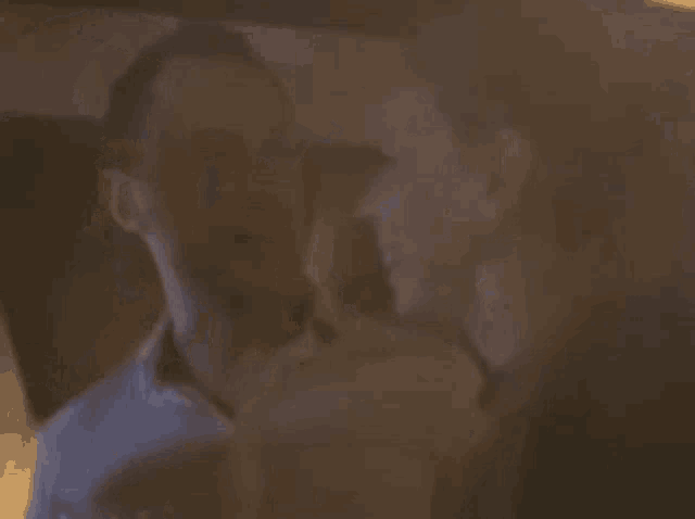 a man and a woman are sitting next to each other in a dark room .
