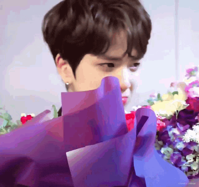 a close up of a person holding a bouquet of flowers .