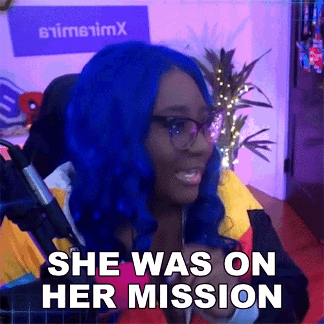 a woman with blue hair and glasses is smiling and saying she was on her mission