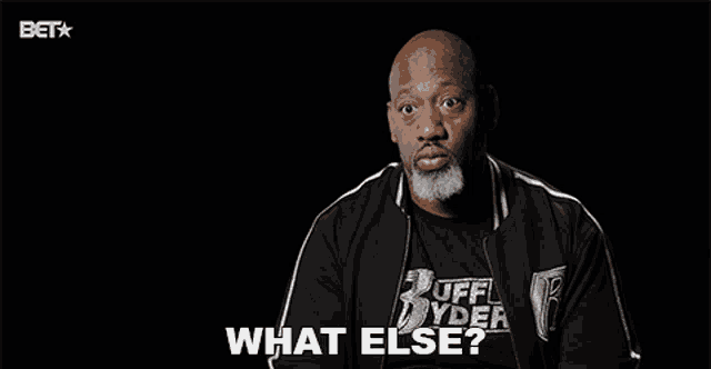a man wearing a black shirt that says ruff ryder on it