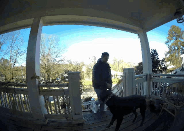 a man stands on a porch with a dog and a bottle of milk