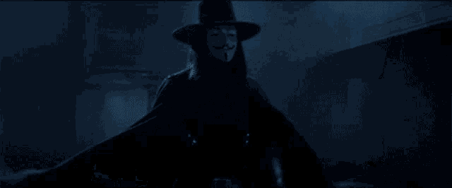 a man in a hat is holding a knife in his right hand