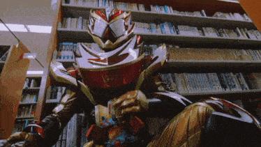 a man in a red and gold costume is sitting in front of a bookshelf