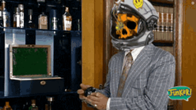 a man in a suit has a helmet with a skull on it