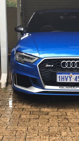 a blue audi quattro is parked in a driveway