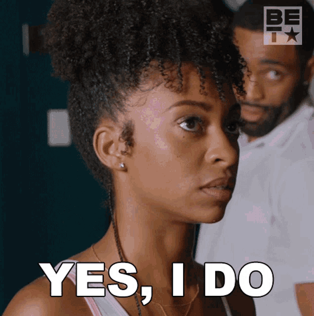 a woman says yes i do with a man behind her