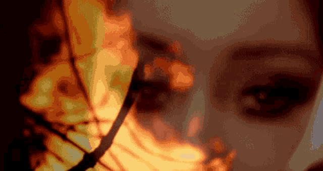 a close up of a woman 's face with a clock behind her