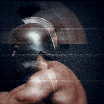 a blurred image of a man with a helmet on