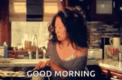 a woman is cooking in a kitchen with the words `` good morning '' written above her .