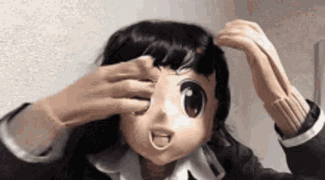 a person wearing a cartoon character mask is covering their eyes with their hands .