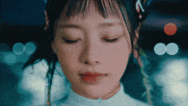 a close up of a woman 's face with closed eyes