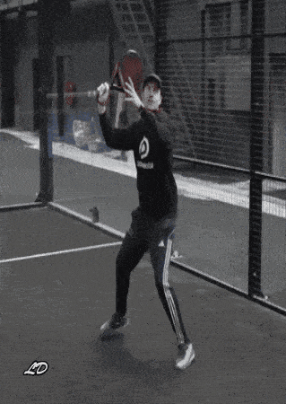 a man wearing a hoodie that says padelable is holding a paddle