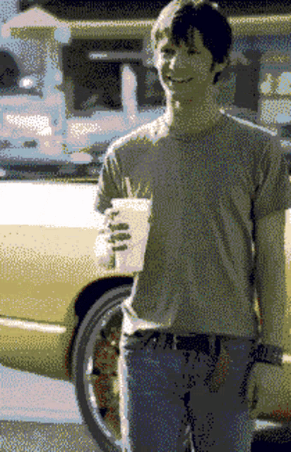 a pixelated image of a man holding a drink