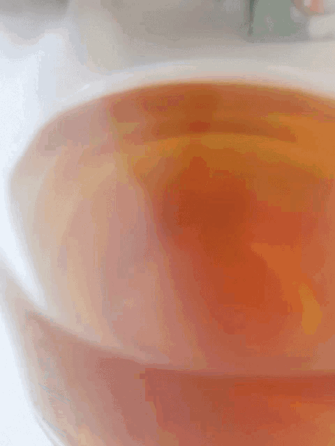 a close up of a cup of tea with a white background