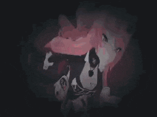 a person is laying on their back on a red surface in a dark room .