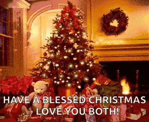 a christmas tree is lit up in a living room next to a fireplace and gifts .