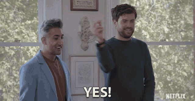 two men standing next to each other and one of them is saying yes