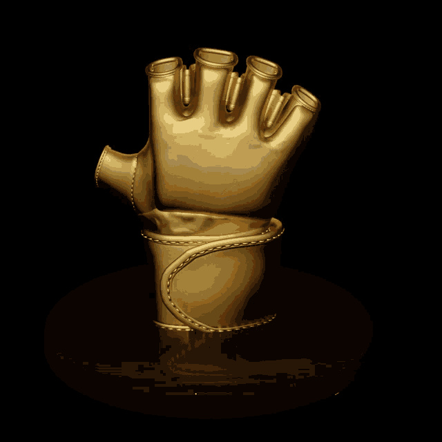 a statue of a gold glove with a black background