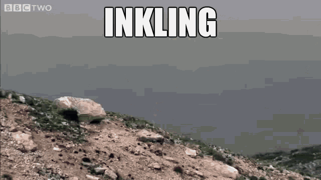 a car is flying through the air on top of a rocky hill with the words inkling above it .