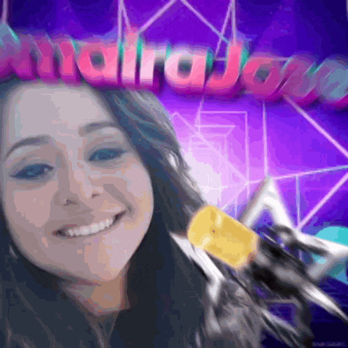 a woman is smiling in front of a purple background that says ' malraja '