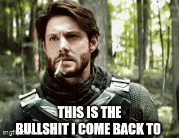 a man with a beard is smoking a cigarette in the woods and says `` this is the bullshit i come back to ''