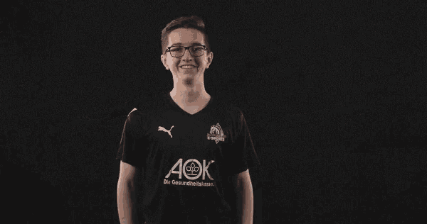 a young man wearing a black shirt with aok on it