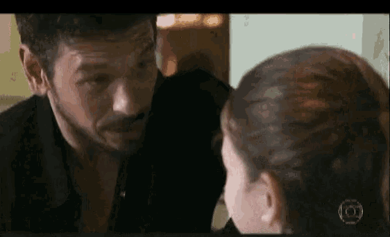 a man and a woman are looking at each other and the man is wearing a black shirt