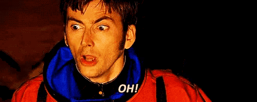 a man in a red jacket is making a funny face and saying oh !