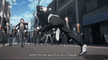 a man is running down a street with a crowd of people behind him .