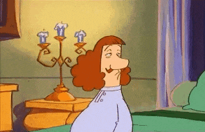 a cartoon character is sitting on a bed next to a candle holder .